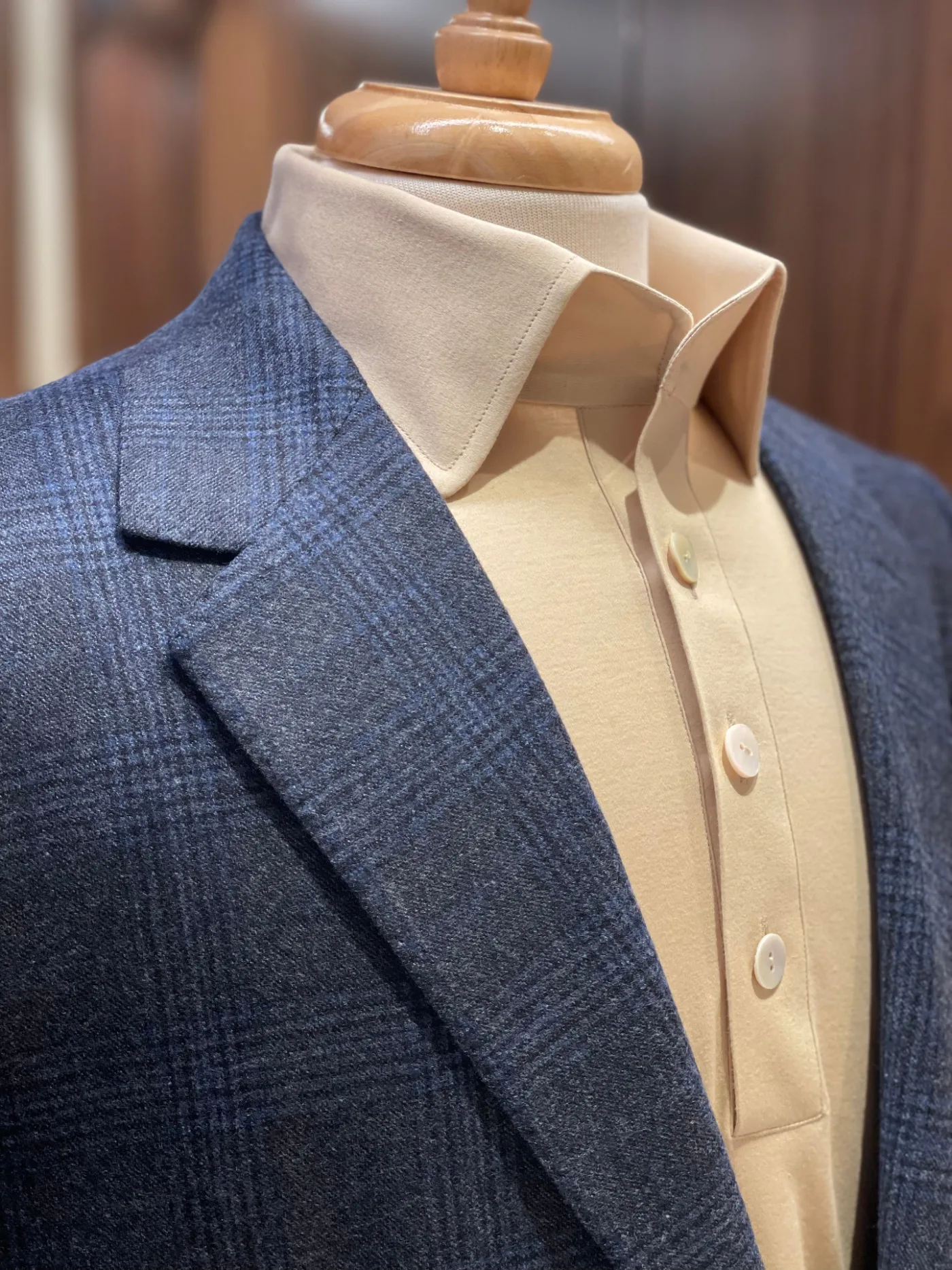 Hand pick-stitching along a shirt collar, pinned to the form