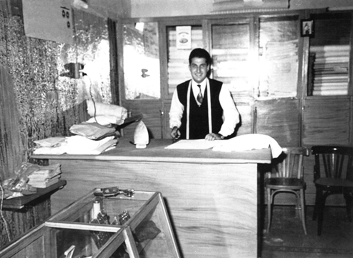 A young Mr. Alex behind the counter